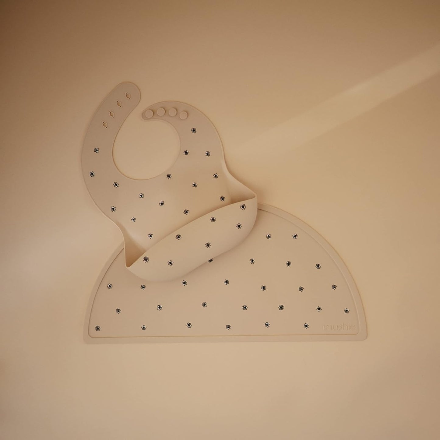 mushie Silicone Baby Bib | Adjustable Fit Waterproof Bibs (Black Daisy)